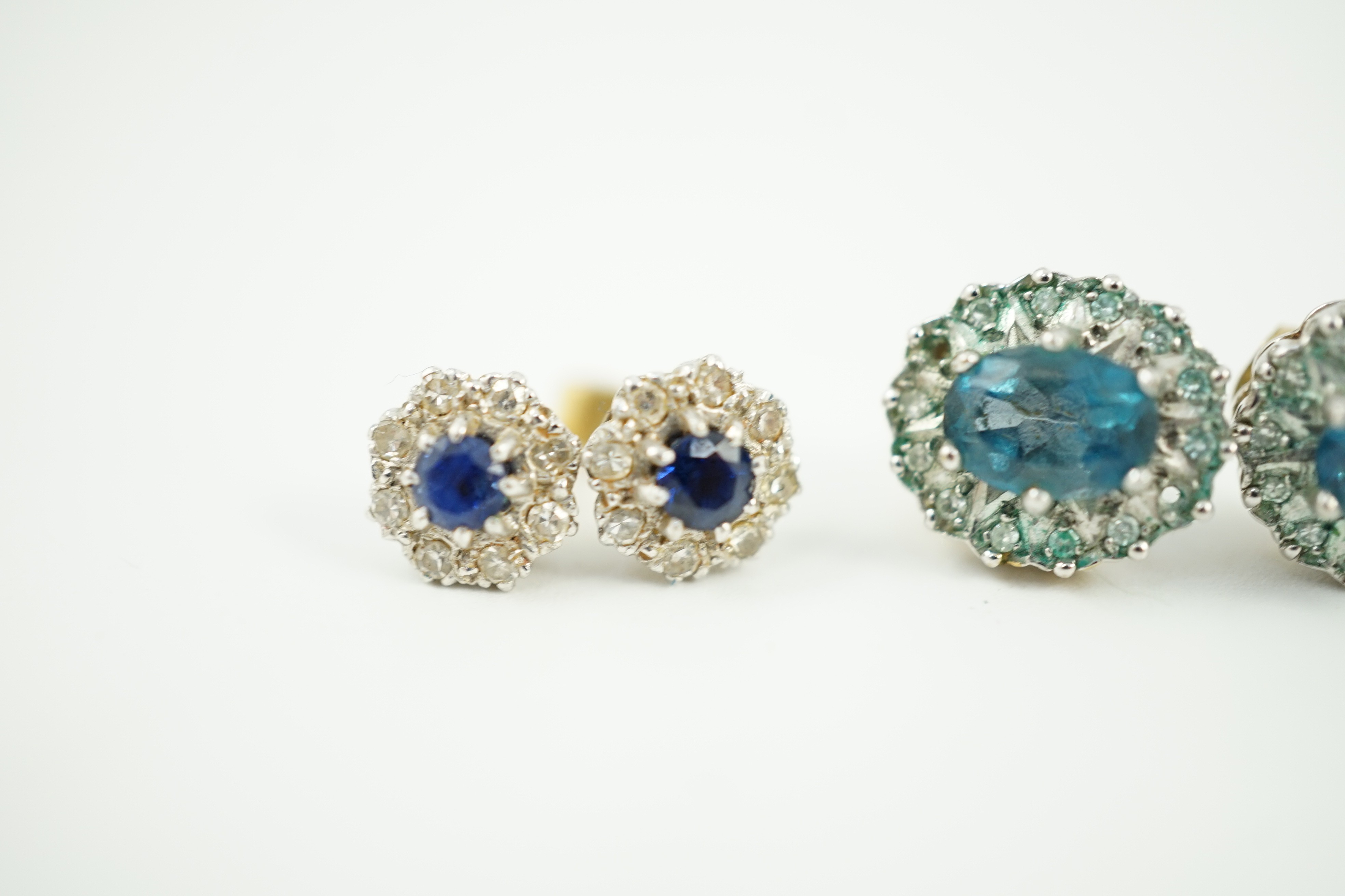 A modern pair of 18ct gold, sapphire and diamond cluster set ear studs, 8mm, gross weight 2.7 grams and a pair of 9ct ear studs, gross 3 grams.